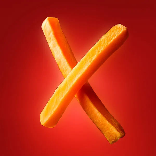 Letter X formed by two crossed french fries on red