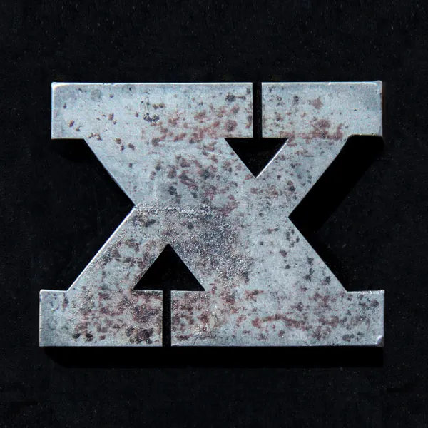 Letter X as worn metal type on black